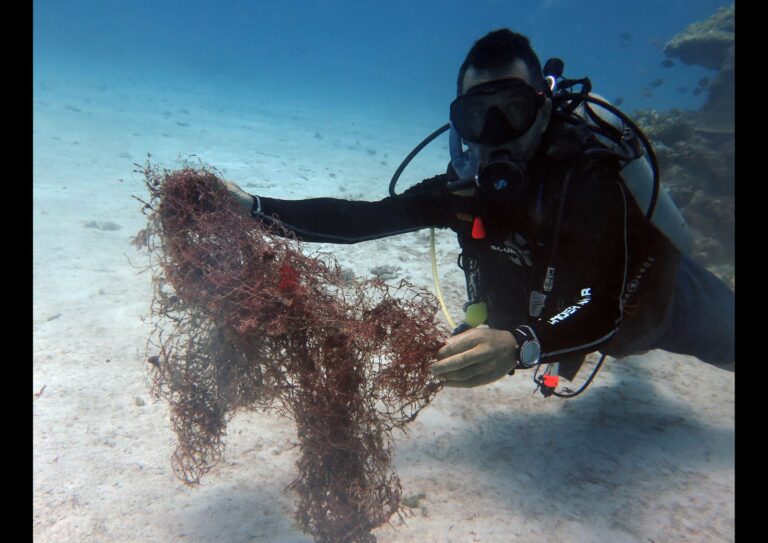 removing nets and trash from the ocean while scuba diving in siquijor island philippines